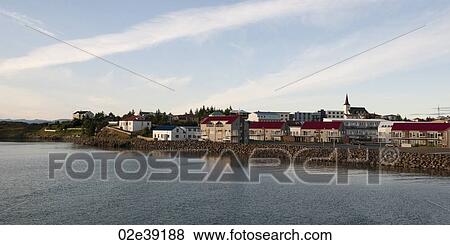 Cityscape, dwellings and steeple on river bank View Large Photo Image Stock Photo - Cityscape, dwellings and steeple on river bank. Fotosearch