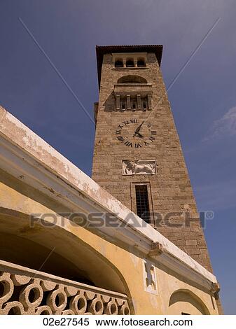 Clock tower at Mandraki Harbour in Rhodes Greece View Large Photo Image Stock Photography - Clock tower at Mandraki Harbour in Rhodes Greece. Fotosearch