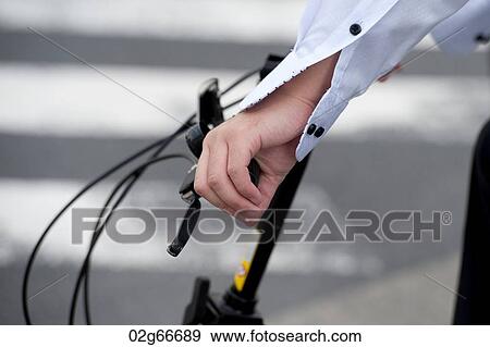 Close-up of a person hand holding a bicycle handlebar, Ginza, Chuo Ward, Tokyo, Japan View Large Photo Image Stock Photo - Close-up of a person hand holding a bicycle handlebar, Ginza, Chuo Ward, Tokyo, Japan. Fotosearch