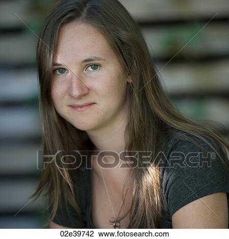 Stock Image - Close up of a young adult woman with long hair. Fotosearch