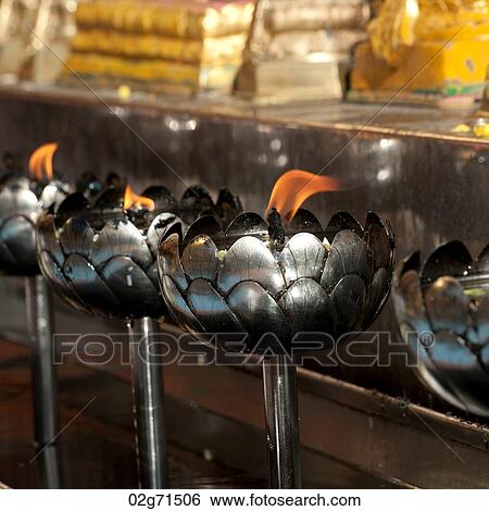 Close-up of oil lamps burning at Wat Phrathat Doi Suthep, Chiang Mai, Thailand View Large Photo Image Stock Photograph - Close-up of oil lamps burning at Wat Phrathat Doi Suthep, Chiang Mai, Thailand. Fotosearch