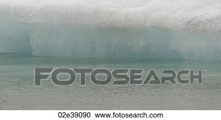 Closeup delicate melting iceberg at water's edge View Large Photo Image Stock Image - Closeup delicate melting iceberg at water's edge. Fotosearch