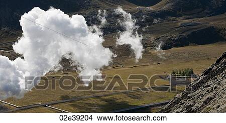 Clouds floating past rocky hillside over farmland valley View Large Photo Image Picture - Clouds floating past rocky hillside over farmland valley. Fotosearch