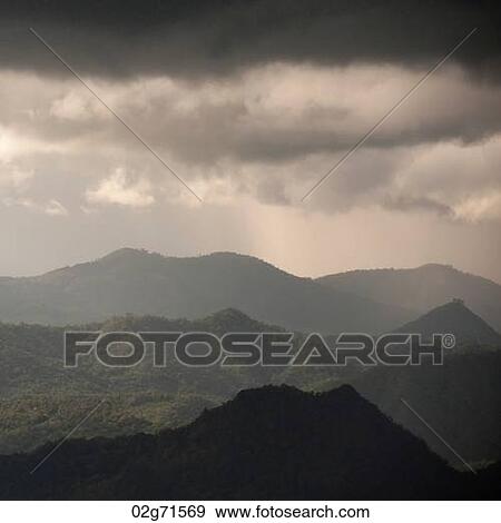 Stock Photo - Clouds over a mountain range, Thailand. Fotosearch