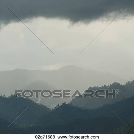 Clouds over a mountain range, Thailand View Large Photo Image Stock Photo - Clouds over a mountain range, Thailand. Fotosearch