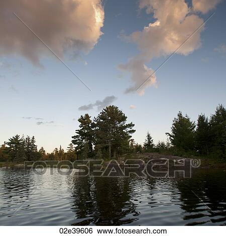 Clouds over lake at Lake of the Woods, Ontario View Large Photo Image Stock Photograph - Clouds over lake at Lake of the Woods, Ontario. Fotosearch