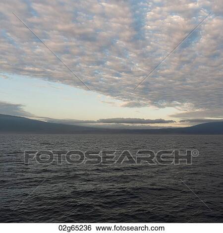 Clouds over the Pacific Ocean at sunset, Isabela Island, Galapagos Islands, Ecuador View Large Photo Image Stock Photograph - Clouds over the Pacific Ocean at sunset, Isabela Island, Galapagos Islands, Ecuador. Fotosearch