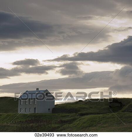 Cloudy evening sky over farmhouse in hilly countryside View Large Photo Image Stock Image - Cloudy evening sky over farmhouse in hilly countryside. Fotosearch
