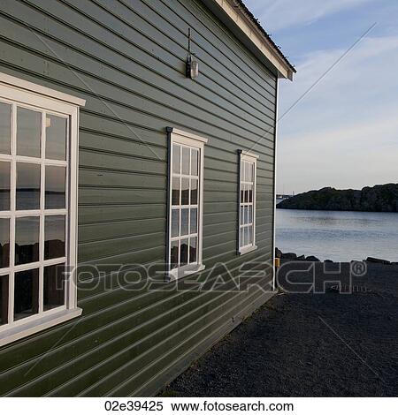 Colourful lakeside dwelling with three multi-paned windows drawing perspective towards the horizon View Large Photo Image Stock Photography - Colourful lakeside dwelling with three multi-paned windows drawing perspective towards the horizon. Fotosearch