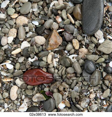 Stock Image - Colourful stones along shoreline in Costa Rica. Fotosearch