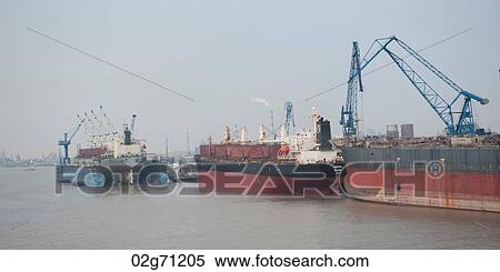 Stock Photography - Container ship at a commercial dock, Yangtze River, Shanghai, China. Fotosearch