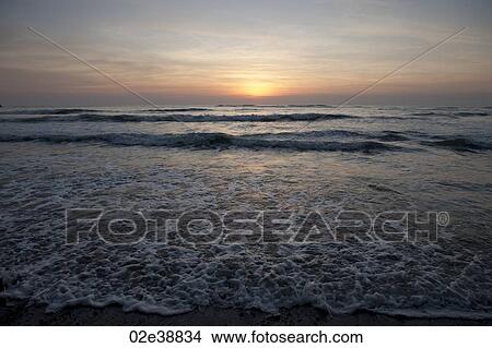 Picture - cool evening sunset over the calm beach Costa Rica. Fotosearch
