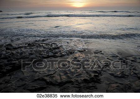 Stock Photography - cool evening sunset over the calm beach Costa Rica. Fotosearch