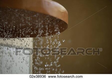 Copper coloured waterfall showerhead with droplets of water View Large Photo Image Stock Photograph - Copper coloured waterfall showerhead with droplets of water. Fotosearch