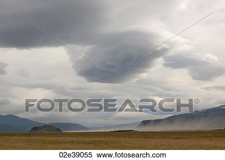 Dark clouded skies and farmland with mountain landscape View Large Photo Image Stock Photography - Dark clouded skies and farmland with mountain landscape. Fotosearch