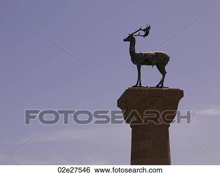 Stock Photograph - Deer statue at Mandraki Harbour in Rhodes Greece. Fotosearch
