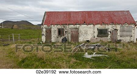 Derelict rundown rural dwelling with overgrown grass and broken rubbish in the yard View Large Photo Image Stock Image - Derelict rundown rural dwelling with overgrown grass and broken rubbish in the yard. Fotosearch