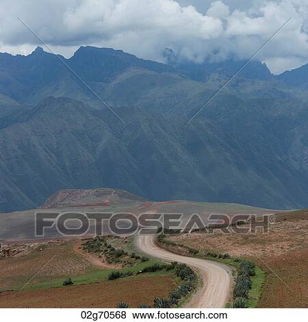 Dirt road passing through a landscape with a mountain range in the background, Sacred Valley, Cusco Region, Peru View Large Photo Image Stock Photo - Dirt road passing through a landscape with a mountain range in the background, Sacred Valley, Cusco Region, Peru. Fotosearch