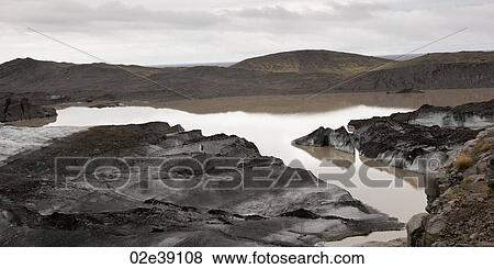 Dirty, muddy melting glaciers next to glacial lake View Large Photo Image Stock Photo - Dirty, muddy melting glaciers next to glacial lake. Fotosearch