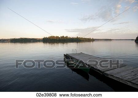 Dock in the water with horizon sky at Lake of the Woods, Ontario View Large Photo Image Stock Photo - Dock in the water with horizon sky at Lake of the Woods, Ontario. Fotosearch
