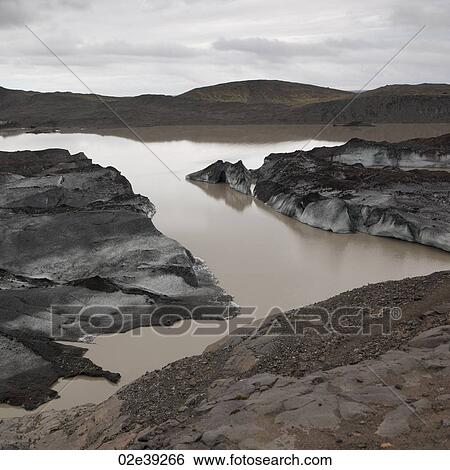 Dusty dirty icebergs on shore of glacial lake View Large Photo Image Stock Photograph - Dusty dirty icebergs on shore of glacial lake. Fotosearch