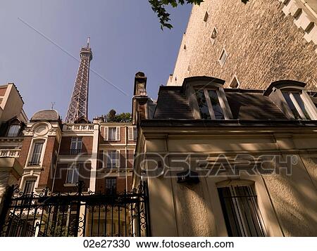 Eiffel Tower behind buildings View Large Photo Image Stock Image - Eiffel Tower behind buildings. Fotosearch