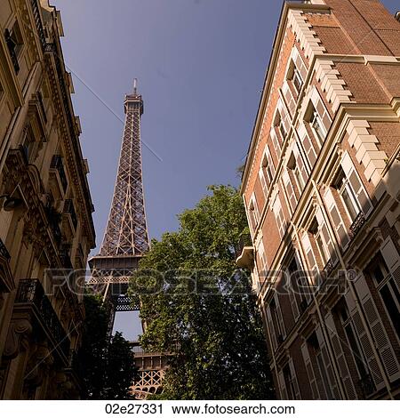 Eiffel Tower behind buildings View Large Photo Image Stock Image - Eiffel Tower behind buildings. Fotosearch