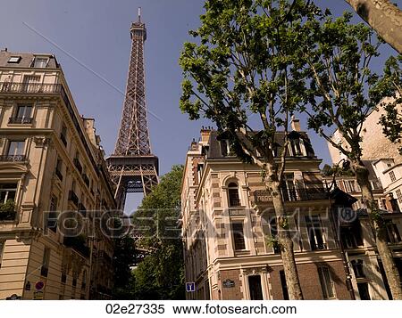 Stock Photography - Eiffel Tower behind buildings. Fotosearch