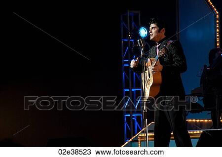 Stock Image - Elvis Presley impersonator performing in Branson, Missouri, U. S. A.. Fotosearch