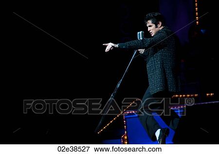 Elvis Presley impersonator performing in Branson, Missouri, U. S. A. View Large Photo Image Stock Photo - Elvis Presley impersonator performing in Branson, Missouri, U. S. A.. Fotosearch