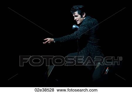 Elvis Presley impersonator performing in Branson, Missouri, U. S. A. View Large Photo Image Stock Photo - Elvis Presley impersonator performing in Branson, Missouri, U. S. A.. Fotosearch