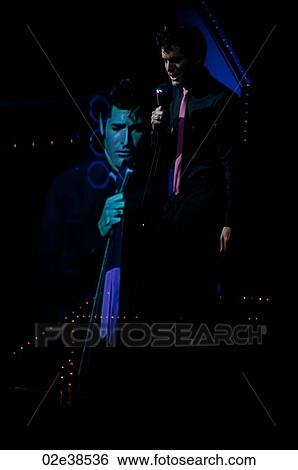 Elvis Presley impersonator performing in Branson, Missouri, U. S. A. View Large Photo Image Stock Photograph - Elvis Presley impersonator performing in Branson, Missouri, U. S. A.. Fotosearch