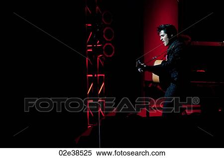 Elvis Presley impersonator performing in Branson, Missouri, U. S. A. View Large Photo Image Stock Photography - Elvis Presley impersonator performing in Branson, Missouri, U. S. A.. Fotosearch