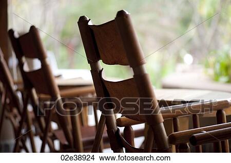 Empty canvas backed wood chairs waiting outside View Large Photo Image Picture - Empty canvas backed wood chairs waiting outside. Fotosearch