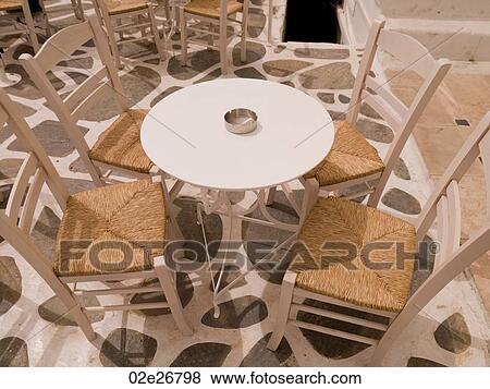 Empty table and chairs in Mykonos Greece View Large Photo Image Stock Photo - Empty table and chairs in Mykonos Greece. Fotosearch