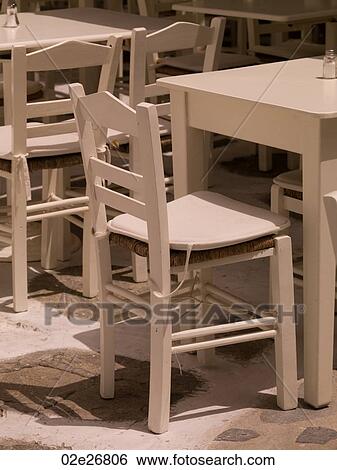 Empty table and chairs in Mykonos Greece View Large Photo Image Stock Photograph - Empty table and chairs in Mykonos Greece. Fotosearch