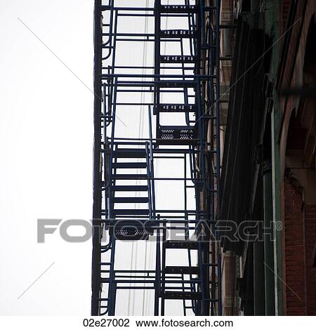 Stock Image - Exterior fire escape in Manhattan, New York City, U. S. A.. Fotosearch
