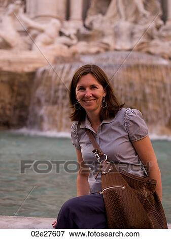 Stock Photo - Female tourist at Trevi Fountain in Rome Italy. Fotosearch