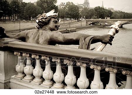 Stock Photo - Figurine on Pont Alexander III Bridge in Paris France. Fotosearch
