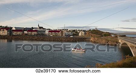 Fishing boat in river, next to town and bridge View Large Photo Image Stock Image - Fishing boat in river, next to town and bridge. Fotosearch