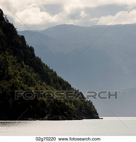 Stock Image - Fjord with mountain range in the background, Sognefjord, Norway. Fotosearch