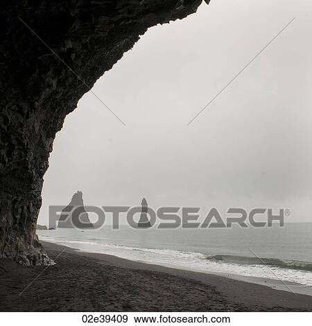 Foggy seascape, framed rock stacks from sea cave View Large Photo Image Stock Photo - Foggy seascape, framed rock stacks from sea cave. Fotosearch