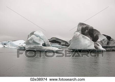 Picture - Frozen blue icebergs in a glacial lake. Fotosearch