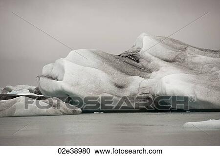 Frozen blue icebergs in a glacial lake View Large Photo Image Stock Image - Frozen blue icebergs in a glacial lake. Fotosearch