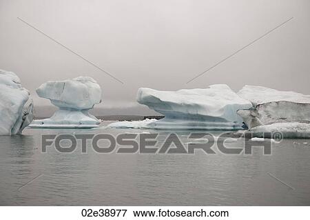 Stock Photo - Frozen blue icebergs in a glacial lake. Fotosearch