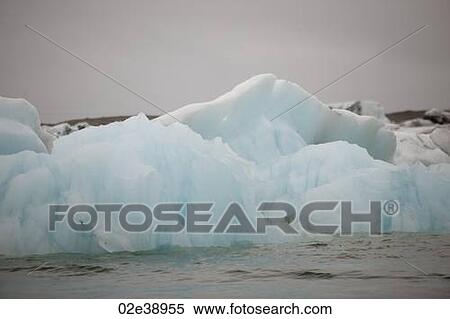 Stock Photography - Frozen blue icebergs in a glacial lake. Fotosearch