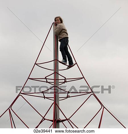 Girl climbing atop triangular rope structure View Large Photo Image Stock Image - Girl climbing atop triangular rope structure. Fotosearch
