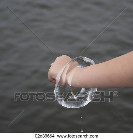 Girl holding a ring of ice View Large Photo Image Picture - Girl holding a ring of ice. Fotosearch