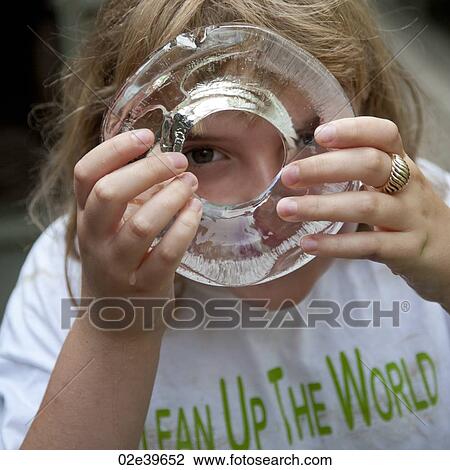 Stock Image - Girl holding a ring of ice. Fotosearch