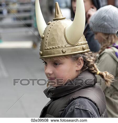 Girl in souvenir plastic horned Viking helmet View Large Photo Image Stock Photo - Girl in souvenir plastic horned Viking helmet. Fotosearch